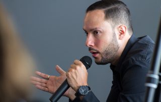 Professional speaker demonstrating microphone feedback control techniques, ideal for an article on ‘Top Tips for Feedback Control with Microphones’.