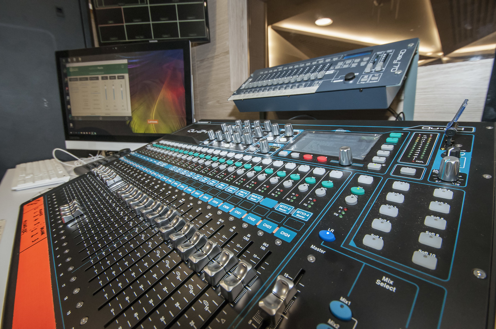 Close-up view of a professional audio mixing console, perfect for an article on debunking myths about valve amplifiers. Vista cercana de una consola de mezcla de audio profesional, perfecta para un artículo sobre desmitificar mitos sobre amplificadores de válvulas.